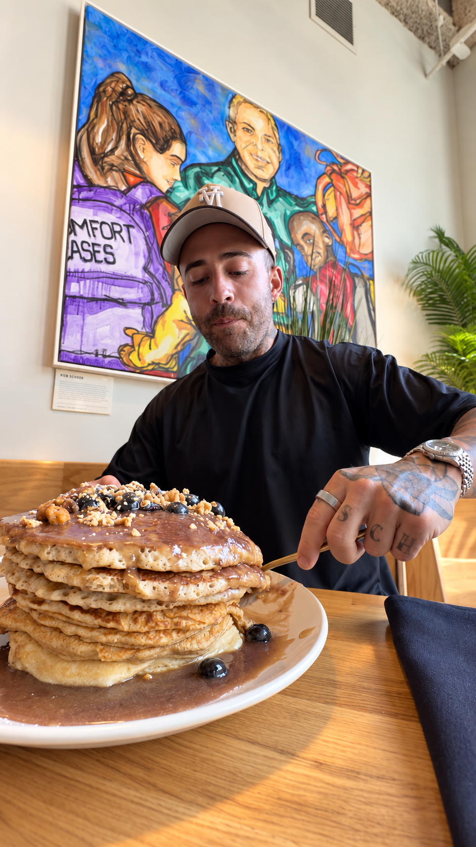 Kyle cutting into the Tower of Power pancake challenge at Hope Breakfast Bar in Minneapolis