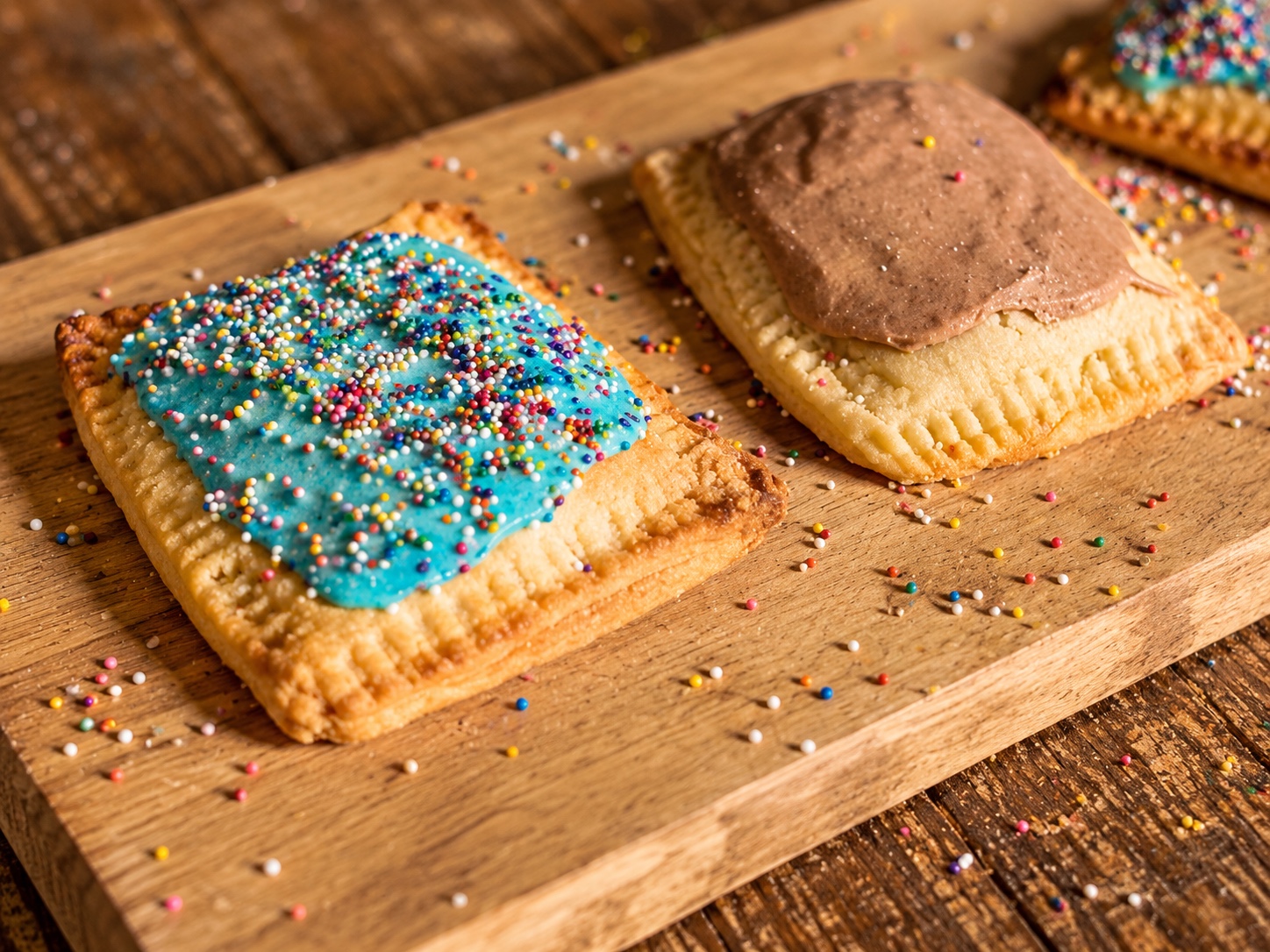 Colorful Pop-Tarts on a wooden board, illustrating our next visit bakery plan